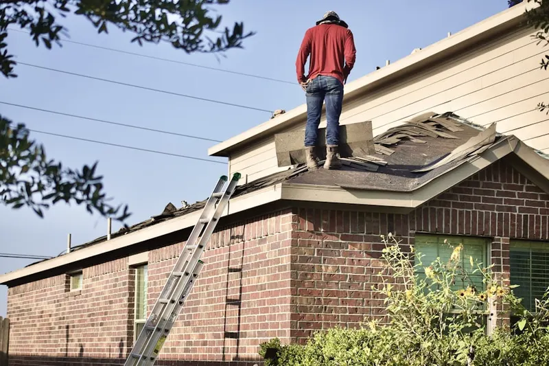 Professional roofer working on a residential roof in Lindgren